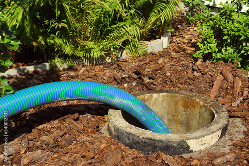 Pipe in the drainage pit. Pumping out sewage from a septic tank.