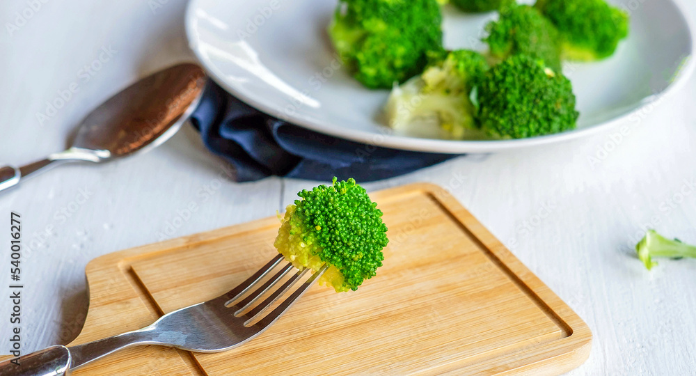 Close-up of green fresh vegetable broccoli. Fresh green broccoli on wooden table.Broccoli vegetable is full of health .Vegetables for diet and healthy eating.Organic food. Close-up of green fresh vegetable broccoli. Fresh green broccoli on wooden table.Broccoli vegetable is full of health .Vegetables for diet and healthy eating.Organic food.