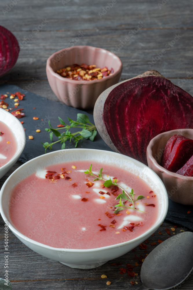 red beetroot soup with chili flakes and thyme, homemade and served in bowls red beetroot soup with chili flakes and thyme, homemade and served in bowls
