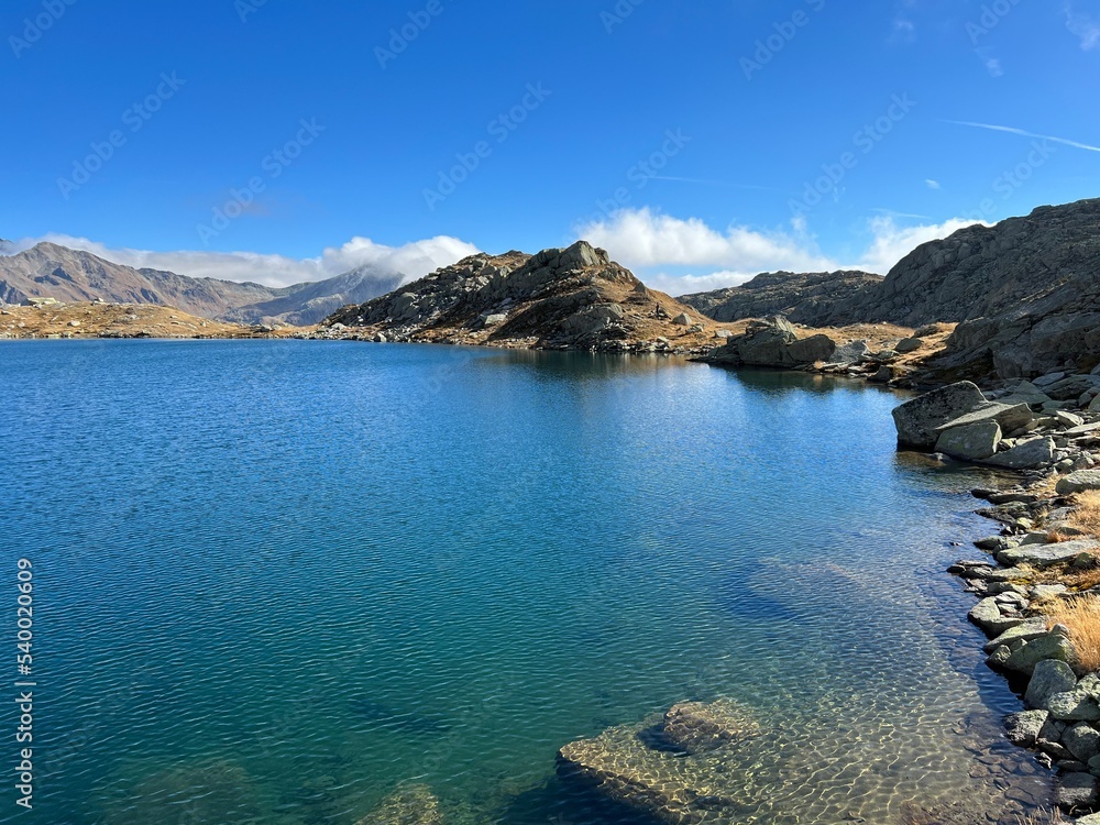 A crystal clear alpine lakes Laghi d'Orsirora during a beautiful autumn day in the mountainous area of the St. Gotthard Pass (Gotthardpass), Airolo - Canton of Ticino (Tessin), Switzerland (Schweiz)