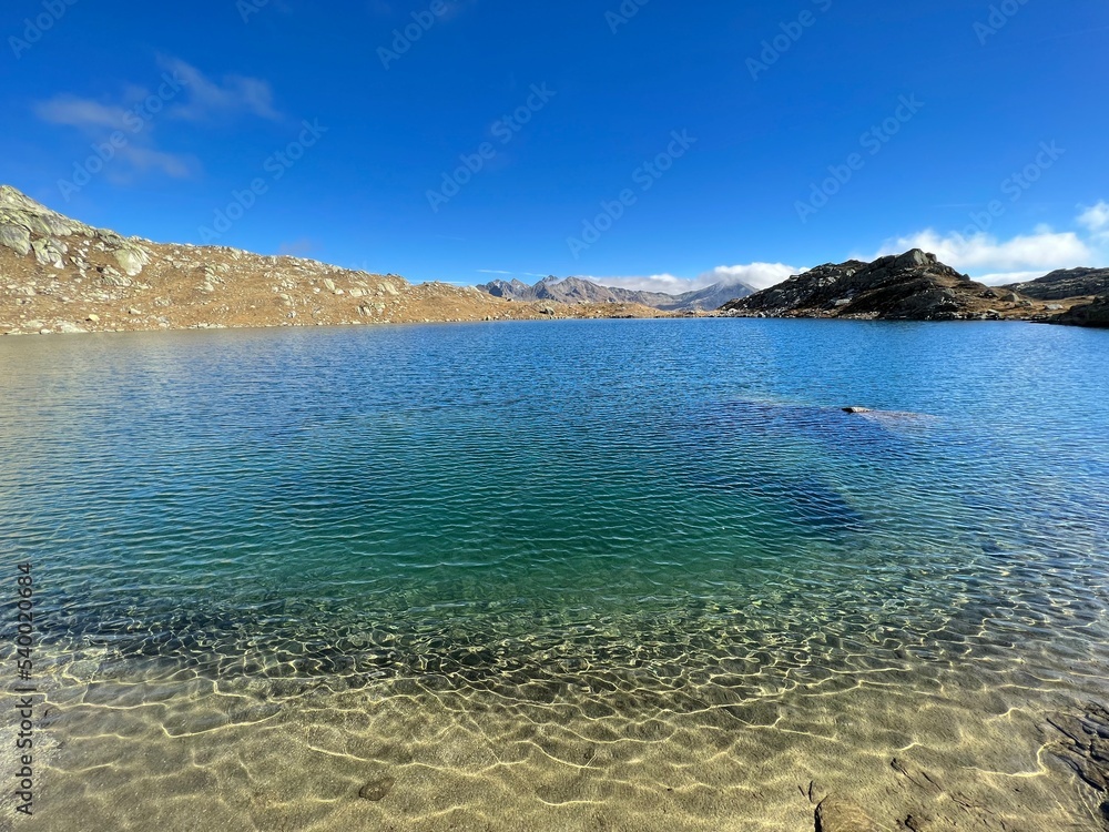 A crystal clear alpine lakes Laghi d'Orsirora during a beautiful autumn day in the mountainous area of the St. Gotthard Pass (Gotthardpass), Airolo - Canton of Ticino (Tessin), Switzerland (Schweiz) A crystal clear alpine lakes Laghi d'Orsirora during a beautiful autumn day in the mountainous area of the St. Gotthard Pass (Gotthardpass), Airolo - Canton of Ticino (Tessin), Switzerland (Schweiz)