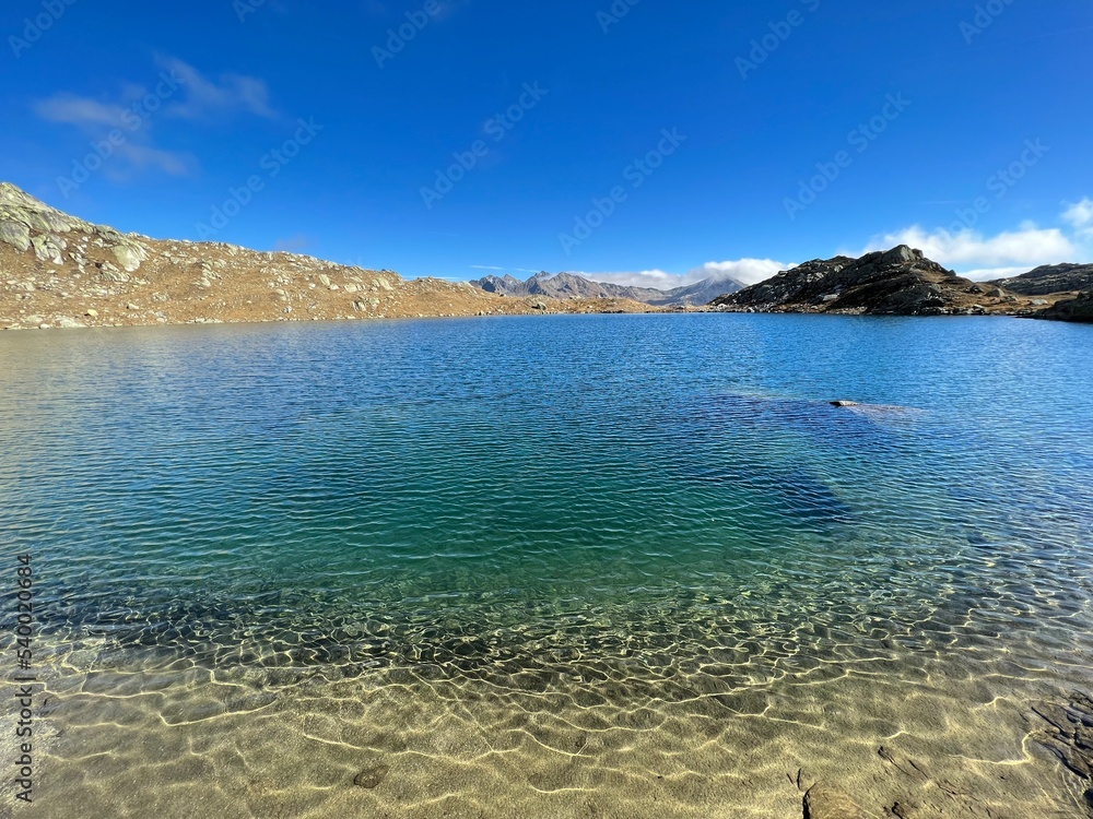 A crystal clear alpine lakes Laghi d'Orsirora during a beautiful autumn day in the mountainous area of the St. Gotthard Pass (Gotthardpass), Airolo - Canton of Ticino (Tessin), Switzerland (Schweiz)