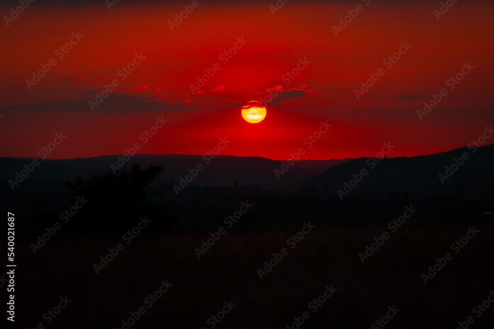 Fototapeta premium Red sunset. Dark mount background