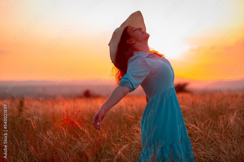 Woman in hat on field wheat with sunset background Woman in hat on field wheat with sunset background
