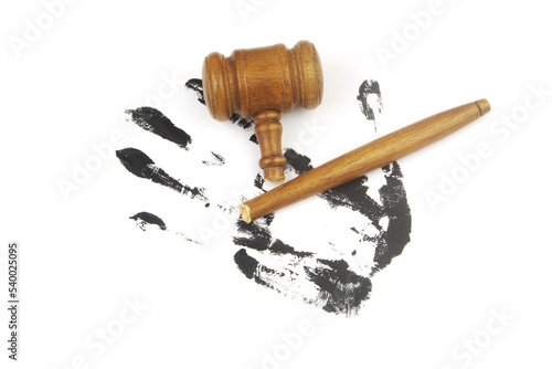Broken judge gavel on black hand print on white background. Crime and injustice concept. photo