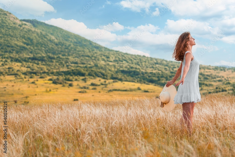 Woman in a hat on field wheat background Woman in a hat on field wheat background