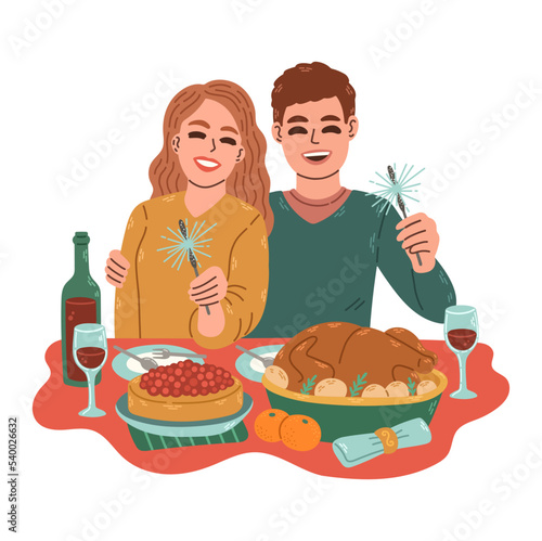 Christmas dinner. Family of two with sparklers red wine in Christmas dinner at home. Man and woman celebrating together
