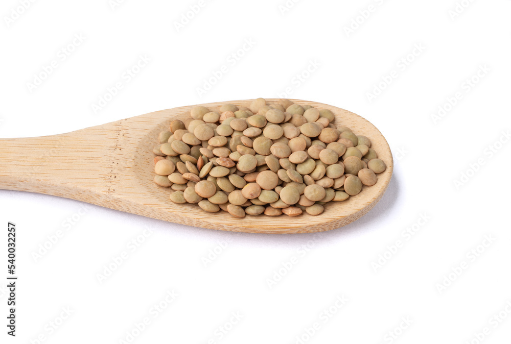 Raw lentils on a spoon isolated over white background Raw lentils on a spoon isolated over white background