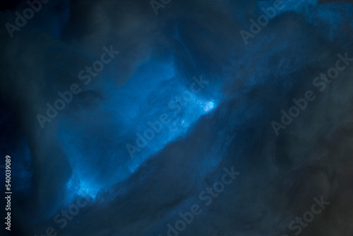 Abstract image made using colored light and cotton snow, artificial snow. Dramatic concept of clouds in the sky, storm at sea, light and dark, atmospheric states. Background or wallpaper. © AAlves