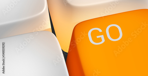 Fotografie Close-up of the word GO written on an orange key.