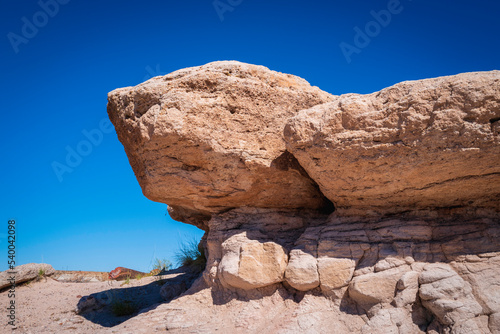 Sandstone rock formation on the hill in Petrified Forest National Park in the town of Holbrook in Northern Arizona, USA. Arid desert wilderness landscape of the Southwest.