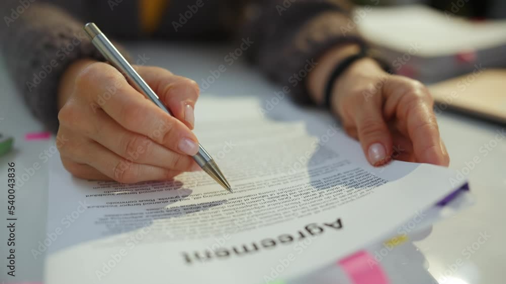 woman reading agreement document.