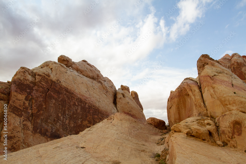 Massive sandstone rock formations in the American southwest desert are ancient fossilized dunes turned to stone and are now being weathered down by wind and rain into individual grains of sand