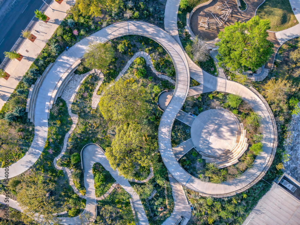 Aerial view of a park with small amphitheater and spiral pathway near the highway at Austin, Texas