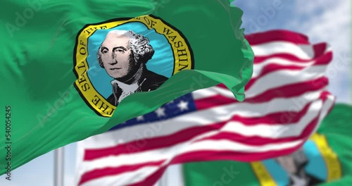 The Washington state flag waving along with the national flag of the United States of America photo