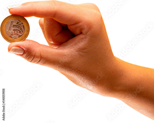 Hand holding one Real coin of Brazil on transparent background. Finance concept. PNG photo