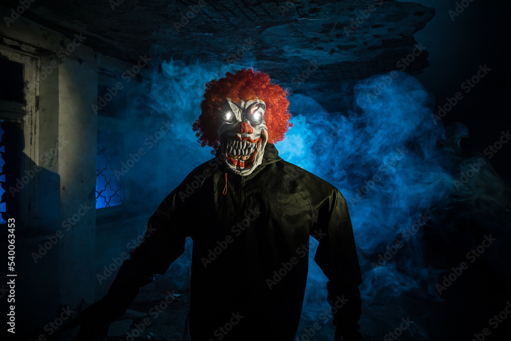 closeup of a scary evil clown with red hair and white eyes, staring at the observer, with a red balloon in front of him, against a black background closeup of a scary evil clown with red hair and white eyes, staring at the observer, with a red balloon in front of him, against a black background