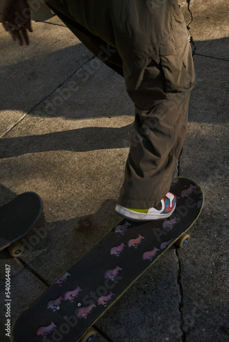 Portrait of young non-binary foot on skateboard 