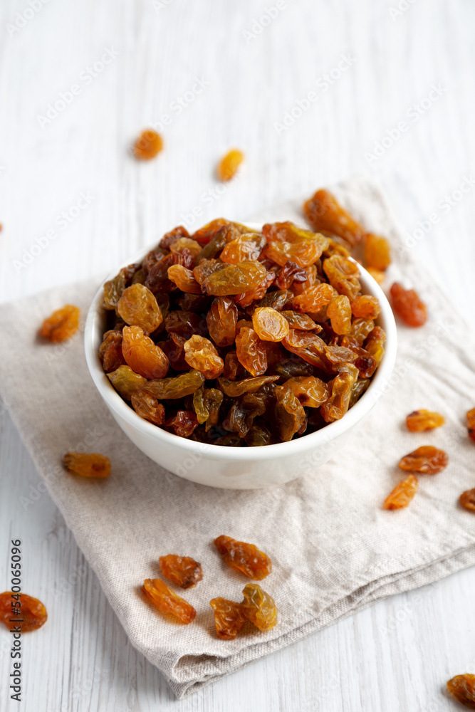 Organic Dried Raisins in a White Bowl, side view. Organic Dried Raisins in a White Bowl, side view.