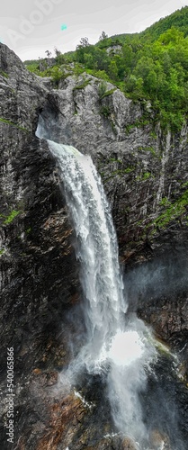 Vertical of the Monafossen waterfall streaming from high cliffs in Norway photo