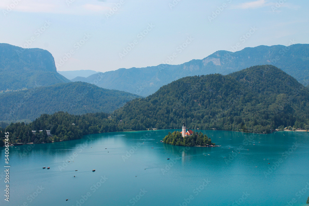 Top view Church in the middle of lake bled in Slovenia with mountains in the background