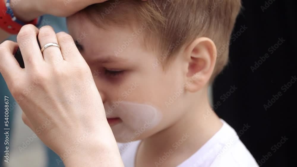 The boy is painted on the face The boy is painted on the face