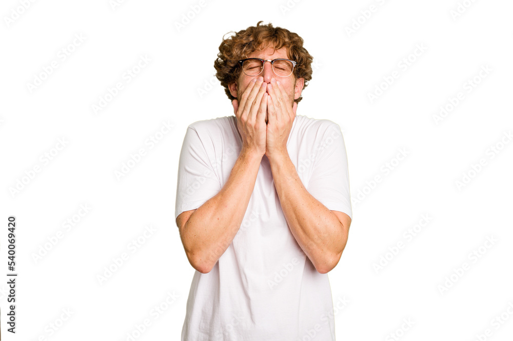 Young caucasian man isolated on green chroma background laughing about something, covering mouth with hands. Young caucasian man isolated on green chroma background laughing about something, covering mouth with hands.