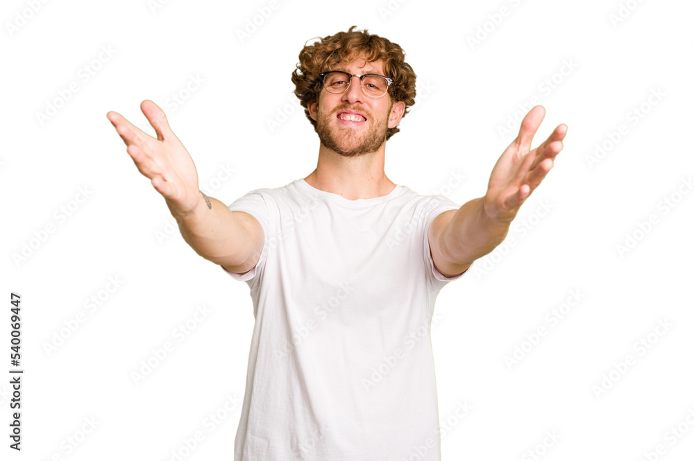 Young caucasian man isolated on green chroma background feels confident giving a hug to the camera. Young caucasian man isolated on green chroma background feels confident giving a hug to the camera.