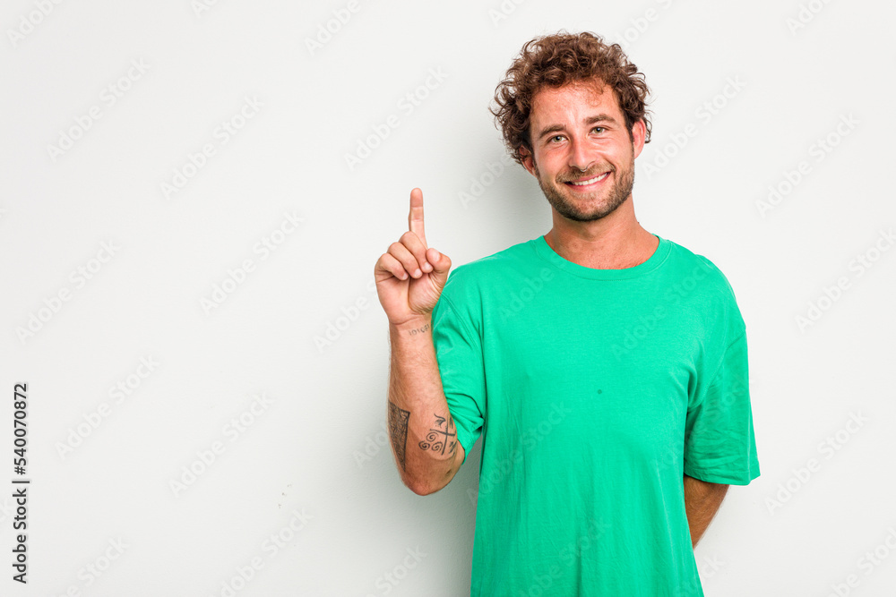 Young caucasian curly hair man isolated on white background showing number one with finger. Young caucasian curly hair man isolated on white background showing number one with finger.
