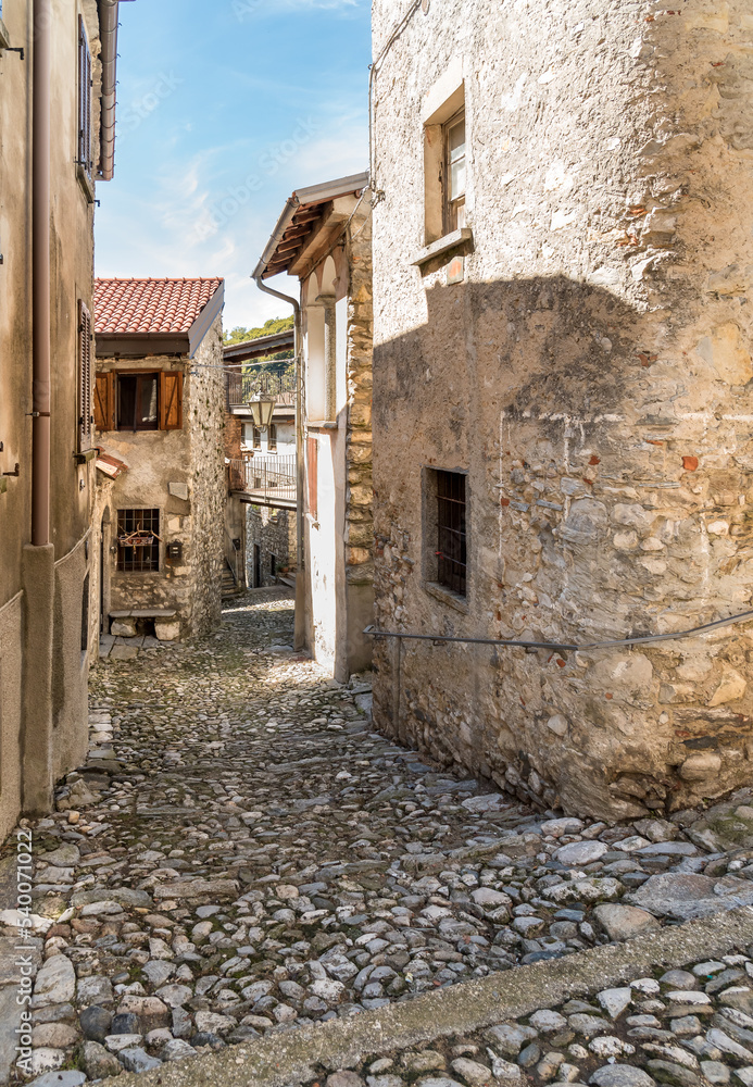 Narrow cobblestones streets in ancient painted village Arcumeggia in province of Varese.