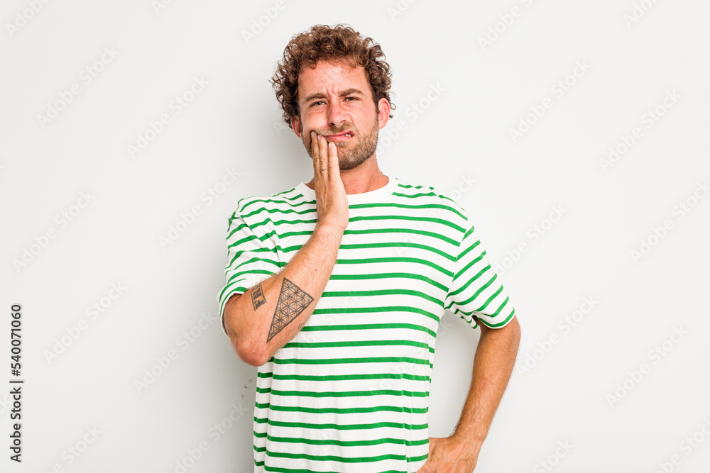 Young caucasian curly hair man isolated on white background having a strong teeth pain, molar ache. Young caucasian curly hair man isolated on white background having a strong teeth pain, molar ache.
