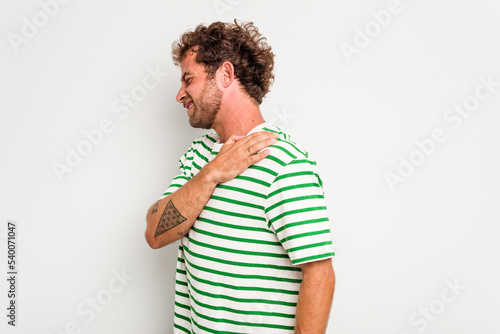 Young caucasian curly hair man isolated on white background having a shoulder pain.