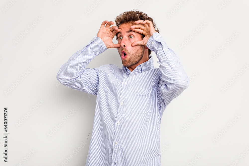 Young caucasian curly hair man isolated on white background keeping eyes opened to find a success opportunity. Young caucasian curly hair man isolated on white background keeping eyes opened to find a success opportunity.