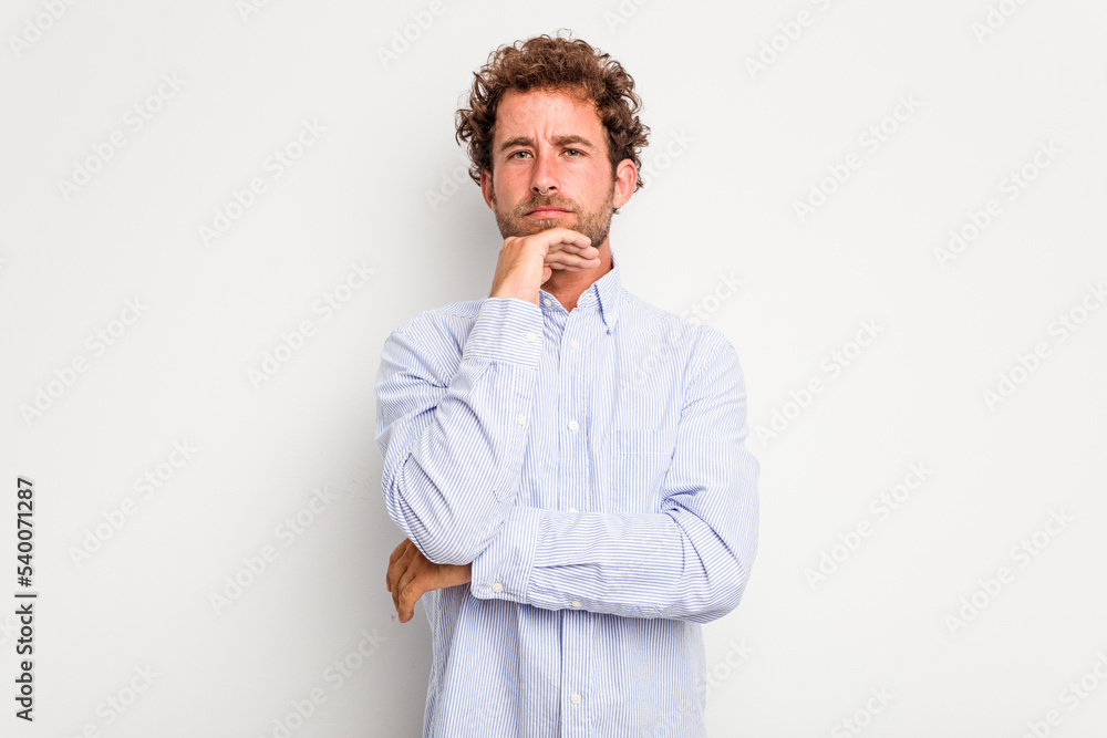 Young caucasian curly hair man isolated on white background suspicious, uncertain, examining you. Young caucasian curly hair man isolated on white background suspicious, uncertain, examining you.