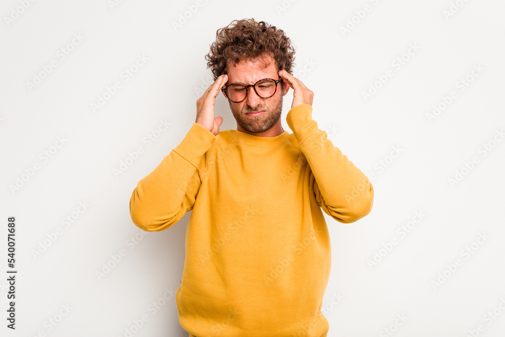 Young caucasian curly hair man isolated on white background having a head ache, touching front of the face. Young caucasian curly hair man isolated on white background having a head ache, touching front of the face.