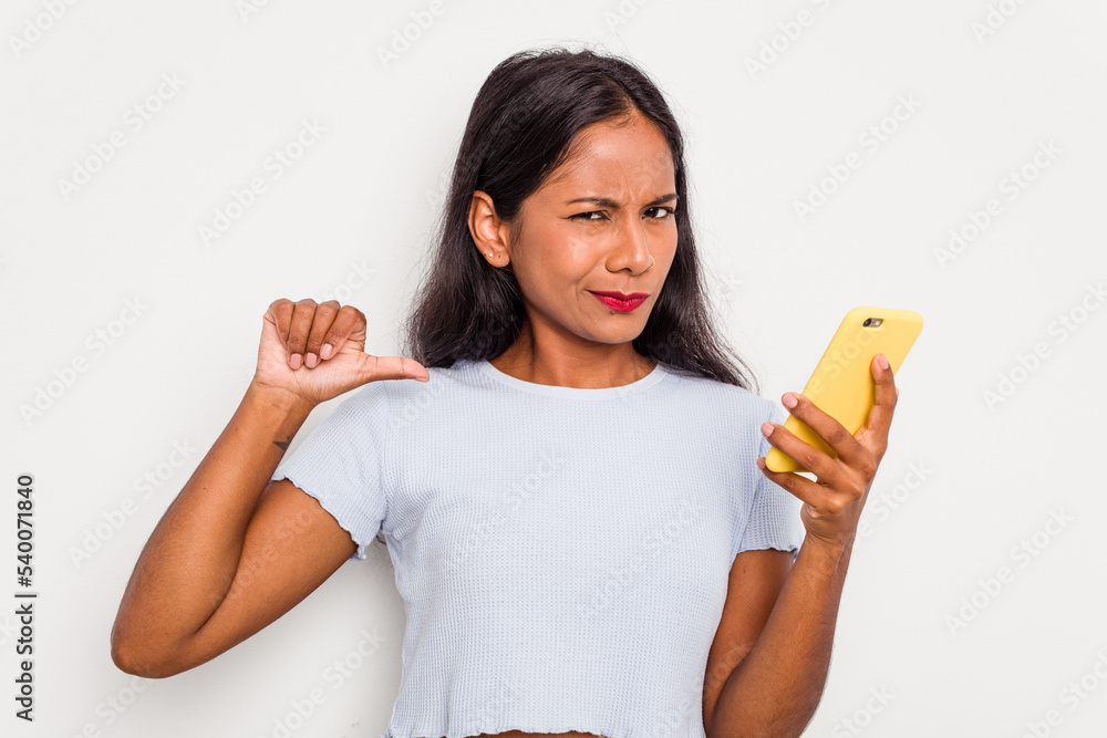 Young indian woman using mobile phone isolated on white background feels proud and self confident, example to follow. Young indian woman using mobile phone isolated on white background feels proud and self confident, example to follow.