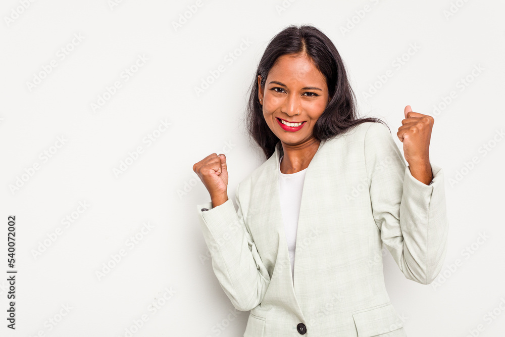 Young business Indian woman isolated on white background raising fist after a victory, winner concept. Young business Indian woman isolated on white background raising fist after a victory, winner concept.