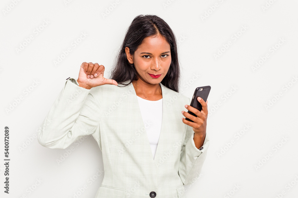 Young business Indian woman holding a mobile phone isolated on white background feels proud and self confident, example to follow. Young business Indian woman holding a mobile phone isolated on white background feels proud and self confident, example to follow.