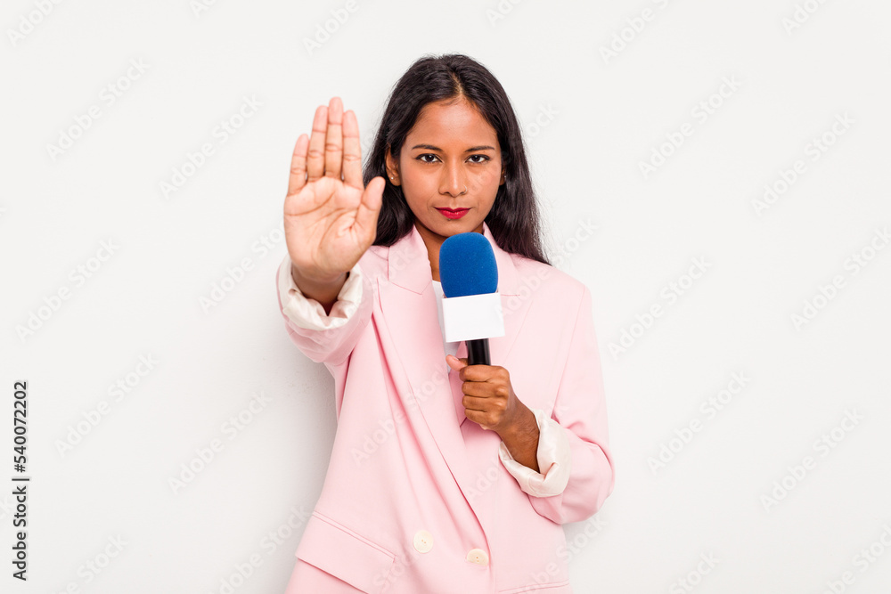 Young TV presenter indian woman isolated on white background standing with outstretched hand showing stop sign, preventing you. Young TV presenter indian woman isolated on white background standing with outstretched hand showing stop sign, preventing you.