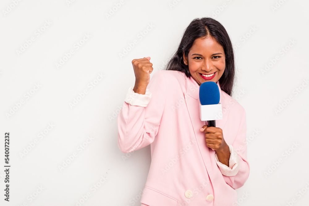 Young TV presenter indian woman isolated on white background raising fist after a victory, winner concept. Young TV presenter indian woman isolated on white background raising fist after a victory, winner concept.
