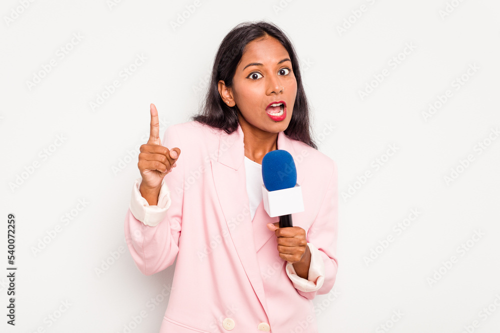 Young TV presenter indian woman isolated on white background having an idea, inspiration concept. Young TV presenter indian woman isolated on white background having an idea, inspiration concept.