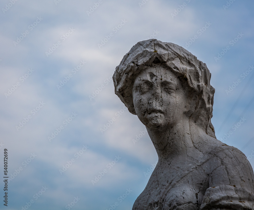 Statue of the Refugium Peccatorum monument near marina water canal in historical centre of Chioggia city, Venetian Lagoon, Verona province, Italy – october 30, 2021