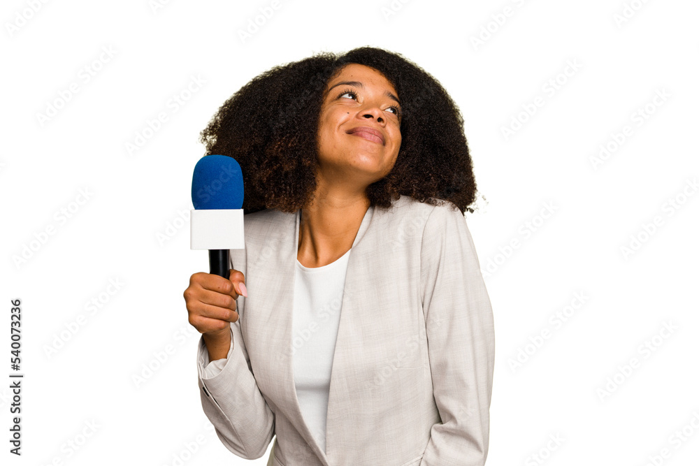 Young TV presenter African American woman with a microphone isolated dreaming of achieving goals and purposes Young TV presenter African American woman with a microphone isolated dreaming of achieving goals and purposes
