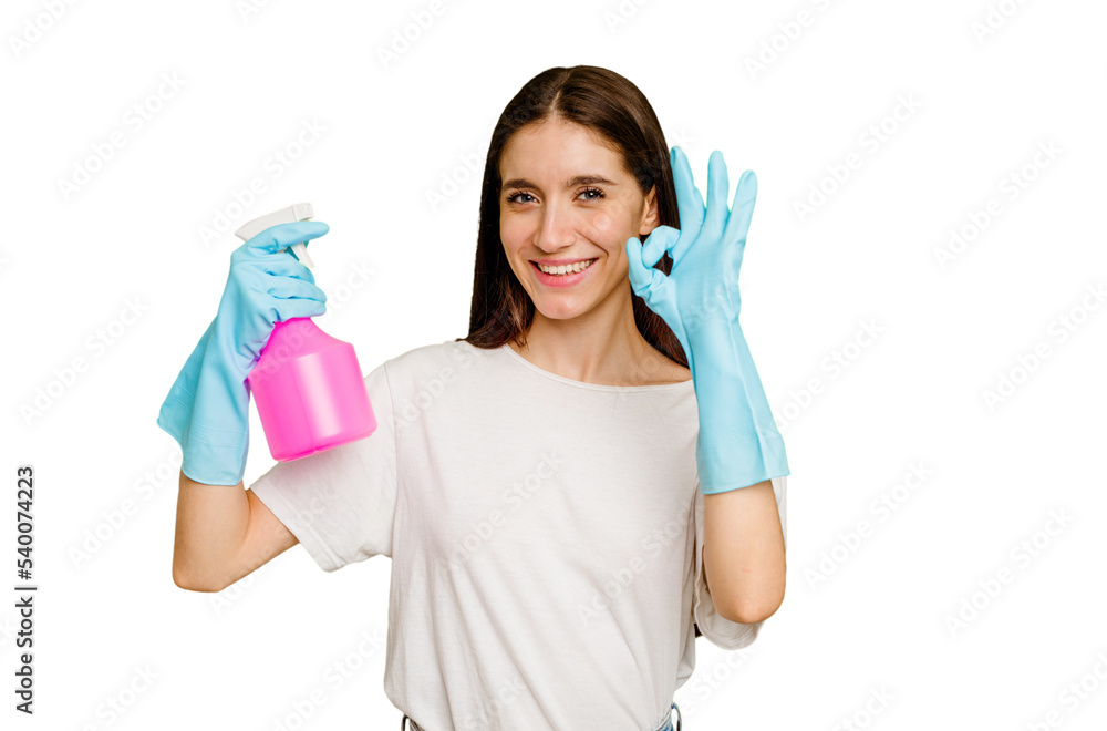 Young cleaner woman isolated cheerful and confident showing ok gesture. Young cleaner woman isolated cheerful and confident showing ok gesture.