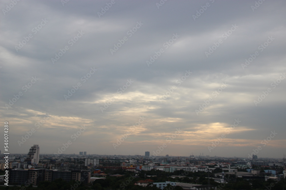 dark storm cloudy sky in rainy day sunset background in city building town