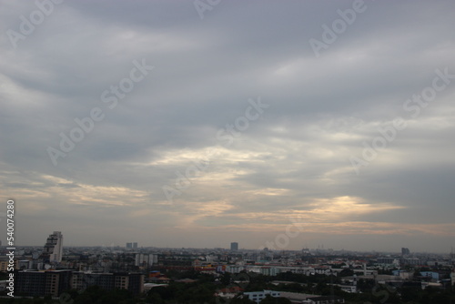 dark storm cloudy sky in rainy day sunset background in city building town