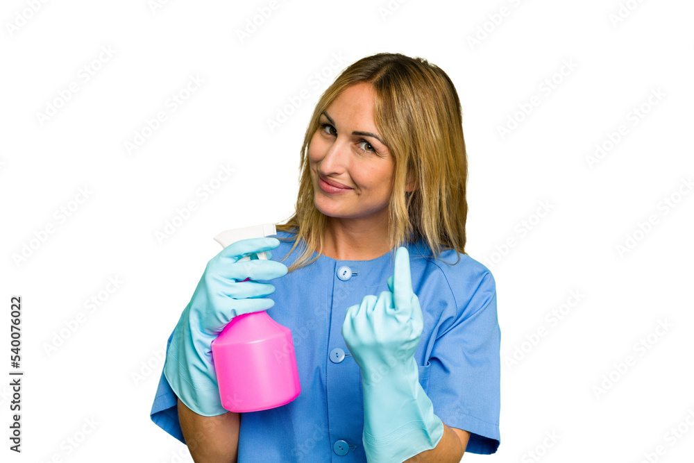 Young cleaner caucasian woman isolated green chroma background pointing with finger at you as if inviting come closer. Young cleaner caucasian woman isolated green chroma background pointing with finger at you as if inviting come closer.