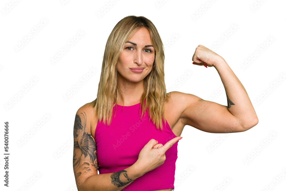 Young caucasian woman isolated on green chroma background showing strength gesture with arms, symbol of feminine power
