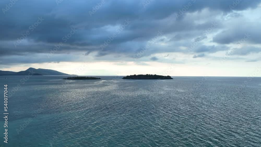 Clouds drift over beautiful, isolated islands found in the Lesser Sunda Islands of Indonesia. This tropical region is home to an extraordinary array of marine biodiversity. Clouds drift over beautiful, isolated islands found in the Lesser Sunda Islands of Indonesia. This tropical region is home to an extraordinary array of marine biodiversity.