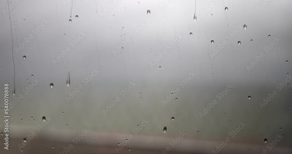 Raindrops flowing down window glass in autumn closeup 4k movie slow motion Raindrops flowing down window glass in autumn closeup 4k movie slow motion